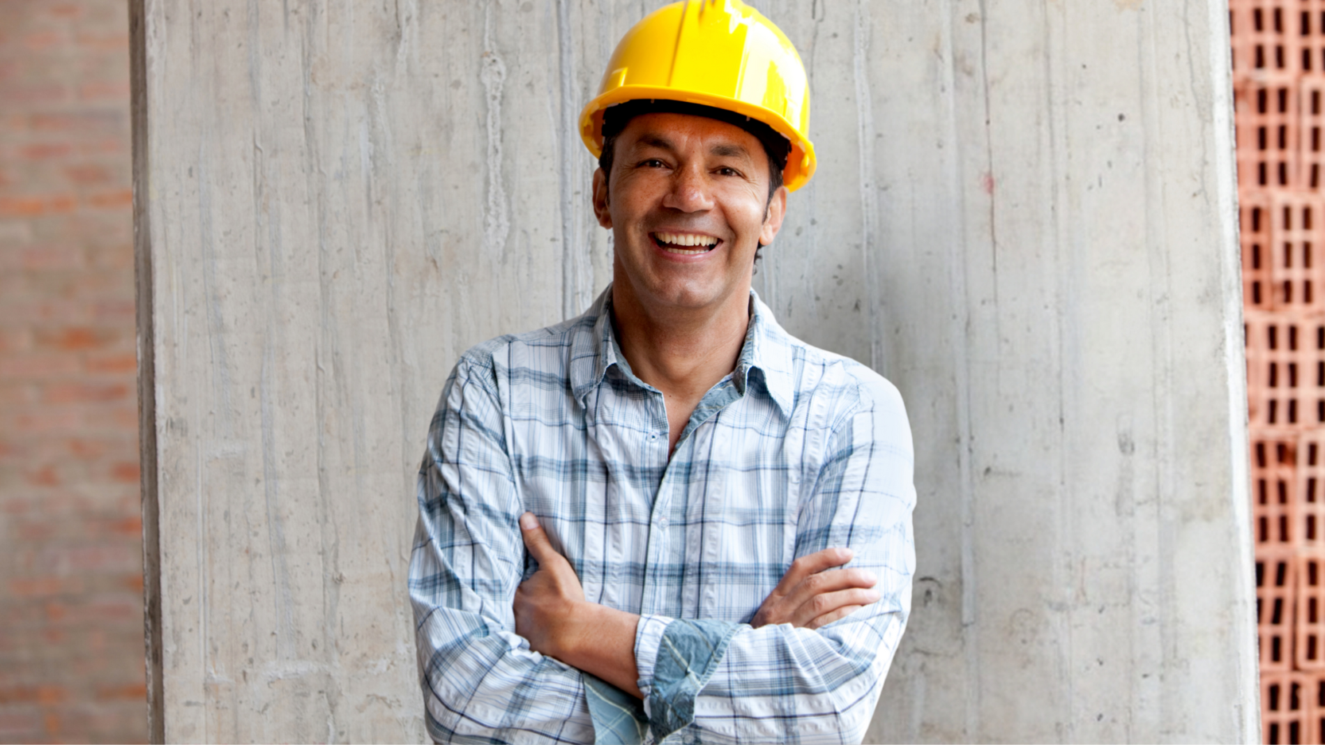 Contractor smiling with a yellow hard hat on